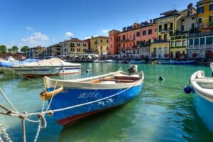 Boats moored along Lago di Garda for vacationers seeking Northern European sunshine.