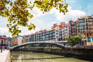 Bilbao downtown with the Nervion river, Ribera bridge and its colorful architecture on a sunny day
